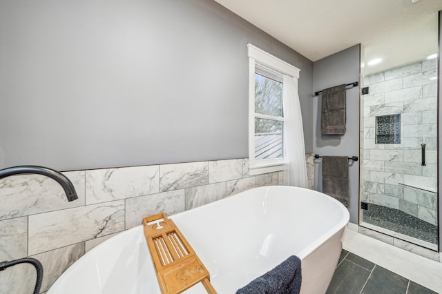 N2699 County Road A, Salem Twp, WI 54750 - bathroom featuring a stall shower, tile walls, a soaking tub, and a wainscoted wall