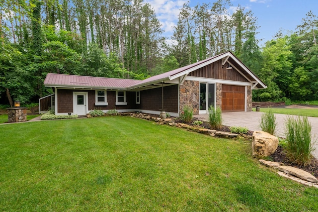 N2699 County Road A, Salem Twp, WI 54750 - view of front of house featuring stone siding, a front lawn, driveway, a metal roof, and a garage