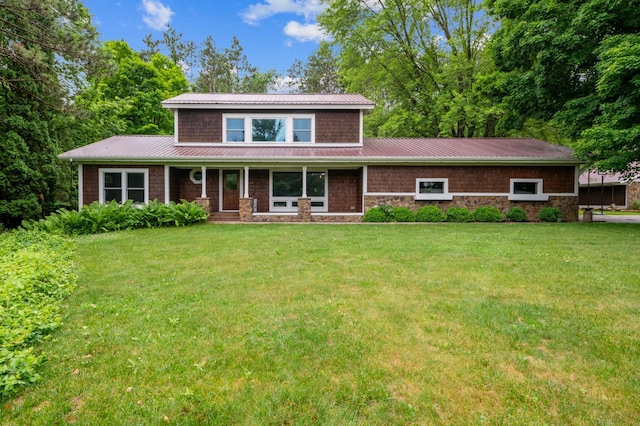 N2699 County Road A, Salem Twp, WI 54750 - traditional-style home with a front lawn, stone siding, a standing seam roof, and a metal roof