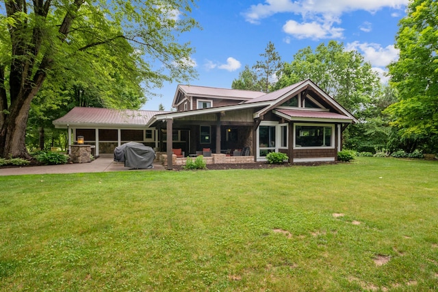 N2699 County Road A, Salem Twp, WI 54750 - view of front of home with a metal roof, a front lawn, and a patio area