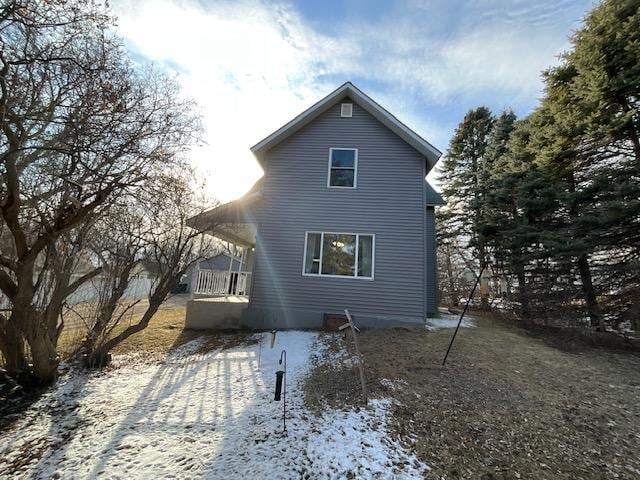 rear view of property with a porch