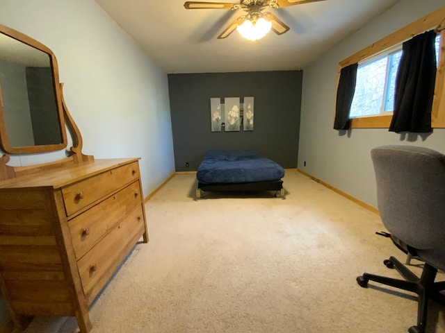 bedroom with baseboards, light carpet, and ceiling fan