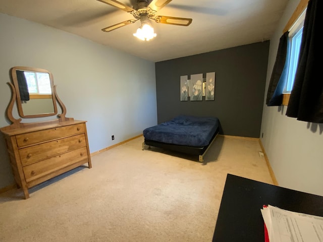 bedroom with a ceiling fan, carpet, and baseboards