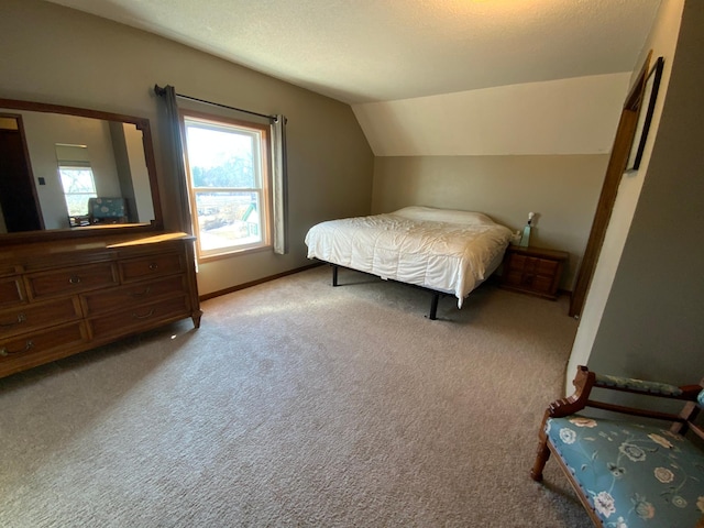 bedroom featuring baseboards, lofted ceiling, carpet, and a textured ceiling