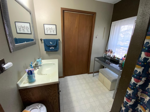 bathroom featuring vanity, tile patterned floors, and baseboards