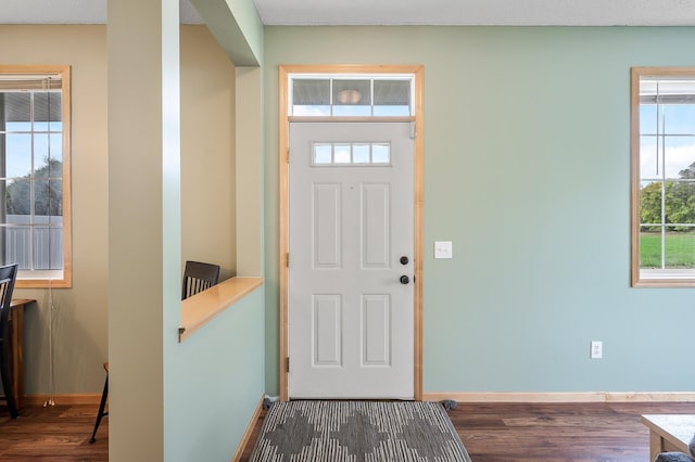 entryway featuring baseboards and wood finished floors