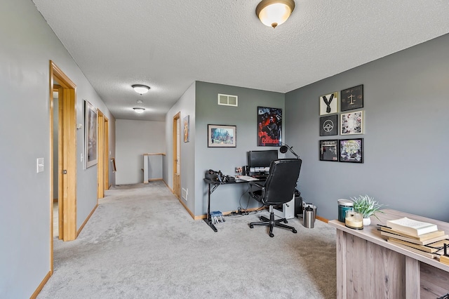 office featuring baseboards, visible vents, carpet floors, and a textured ceiling