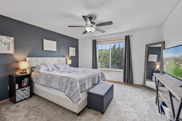 bedroom with baseboards, carpet, ceiling fan, and a textured ceiling