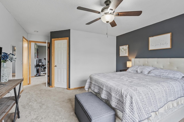 carpeted bedroom with ceiling fan, a textured ceiling, and baseboards