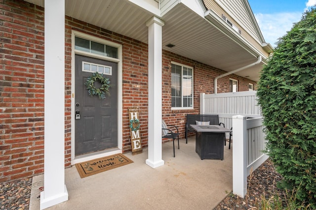 view of exterior entry with brick siding