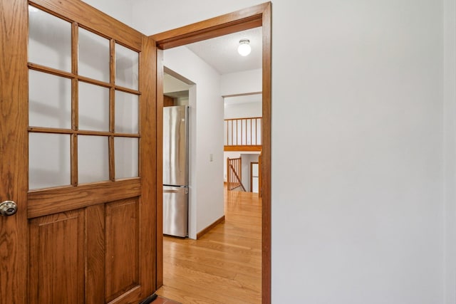 2605 Forest St, Maplewood, MN 55109 - corridor with light wood-style floors, an upstairs landing, and a textured ceiling