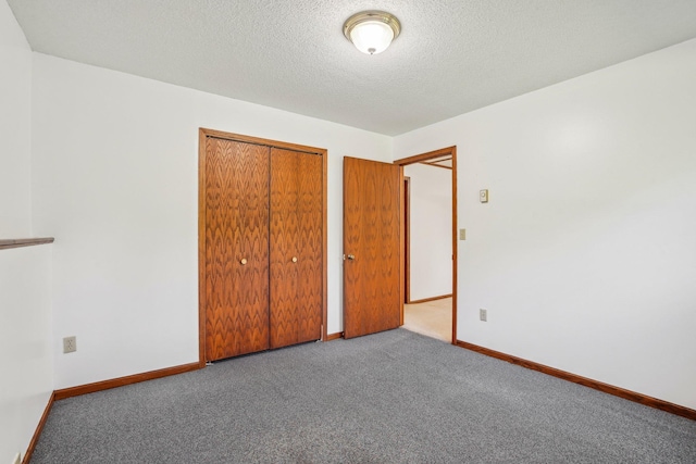 2605 Forest St, Maplewood, MN 55109 - unfurnished bedroom with carpet, a closet, a textured ceiling, and baseboards