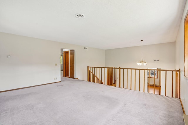 2605 Forest St, Maplewood, MN 55109 - carpeted spare room with a chandelier and a baseboard heating unit