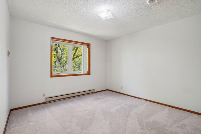 2605 Forest St, Maplewood, MN 55109 - carpeted spare room featuring a baseboard radiator, a textured ceiling, and baseboards