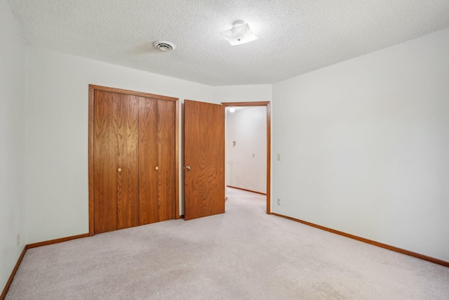 2605 Forest St, Maplewood, MN 55109 - unfurnished bedroom with a closet, light colored carpet, a textured ceiling, and baseboards