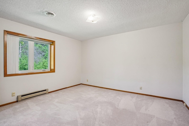 2605 Forest St, Maplewood, MN 55109 - empty room with a baseboard radiator, light colored carpet, baseboards, and a textured ceiling