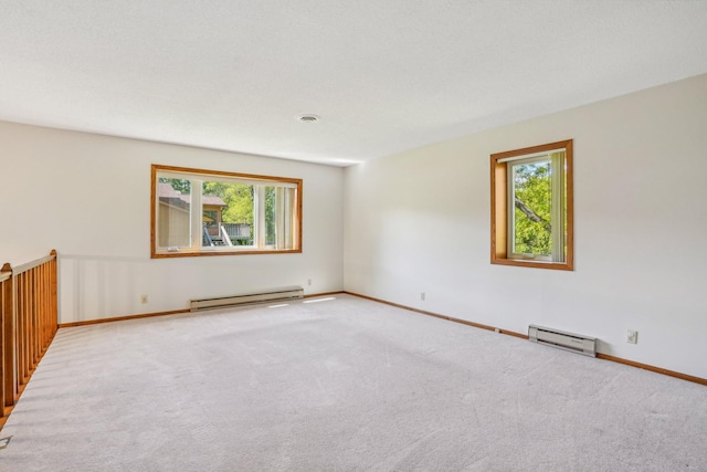 2605 Forest St, Maplewood, MN 55109 - spare room featuring a baseboard radiator, carpet, and baseboards