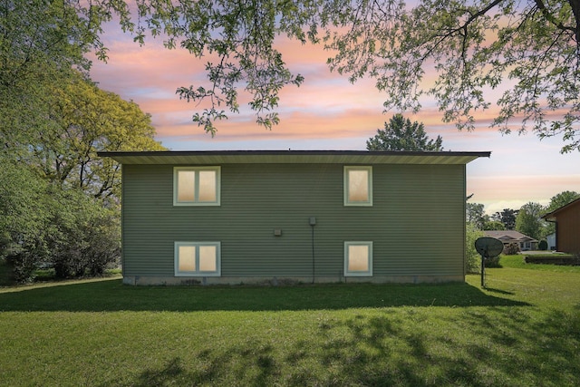 2605 Forest St, Maplewood, MN 55109 - back of house at dusk featuring a lawn