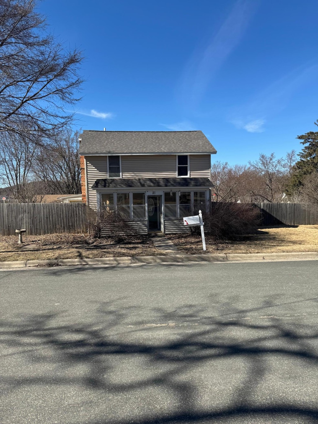 traditional-style home featuring fence