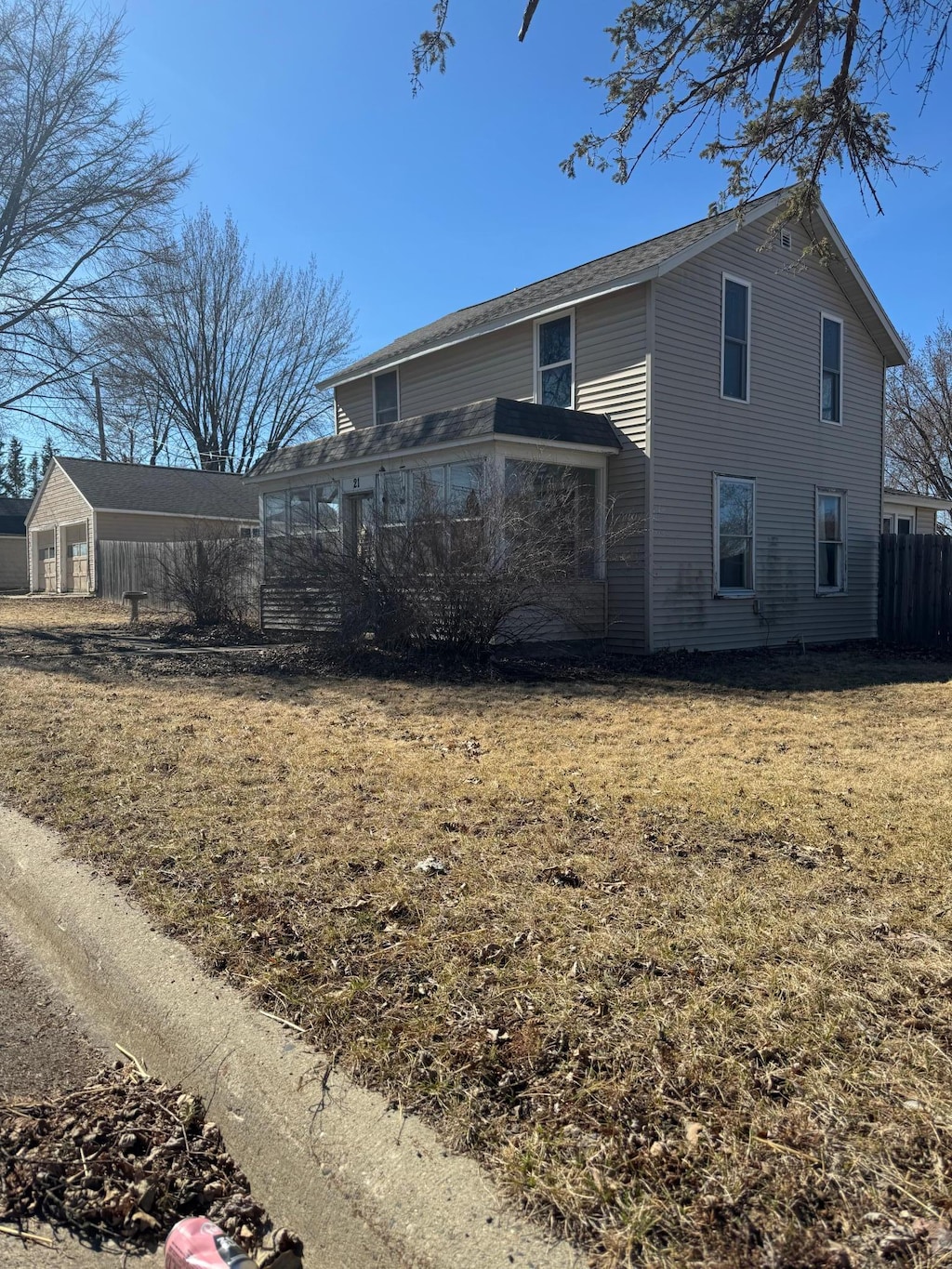 view of property exterior featuring a yard and fence