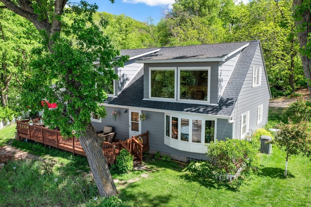 W3527 2nd St, Maiden Rock, WI 54750 - back of property featuring a wooden deck, a shingled roof, and a yard