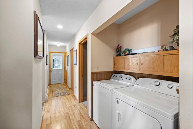 W3527 2nd St, Maiden Rock, WI 54750 - laundry room with independent washer and dryer, light wood-type flooring, wainscoting, and a textured ceiling