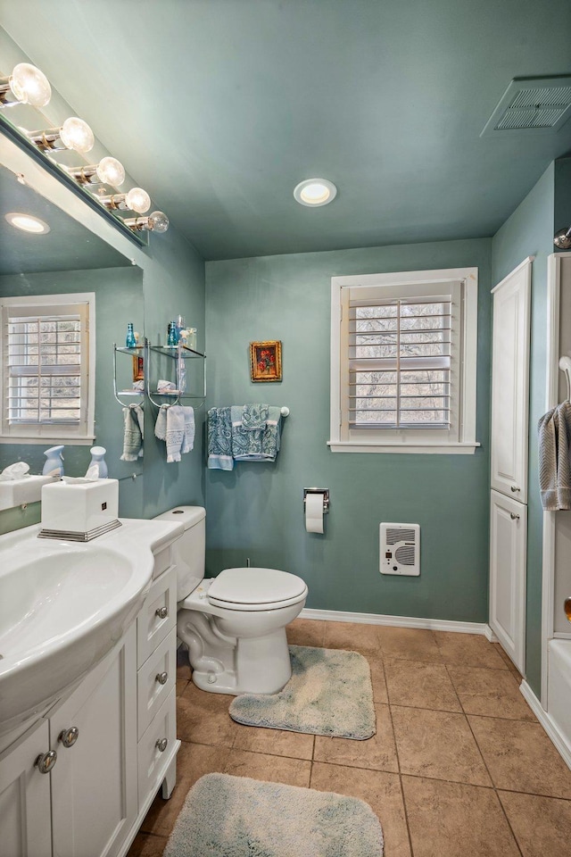 W3527 2nd St, Maiden Rock, WI 54750 - bathroom featuring vanity, heating unit, plenty of natural light, tile patterned floors, and recessed lighting