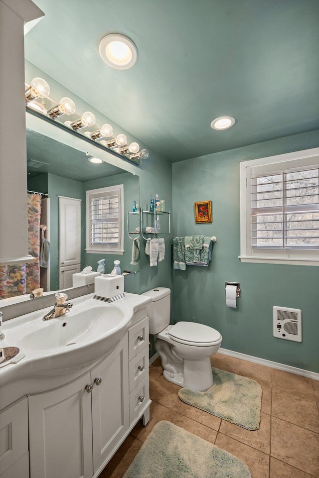 W3527 2nd St, Maiden Rock, WI 54750 - bathroom with vanity, toilet, heating unit, tile patterned floors, and recessed lighting