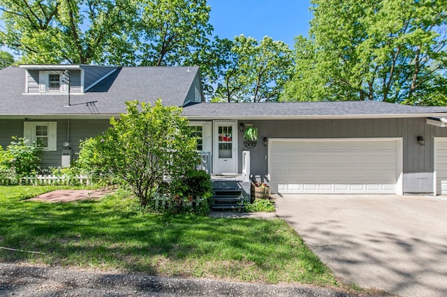 W3527 2nd St, Maiden Rock, WI 54750 - view of front of house with an attached garage, driveway, a front lawn, and roof with shingles