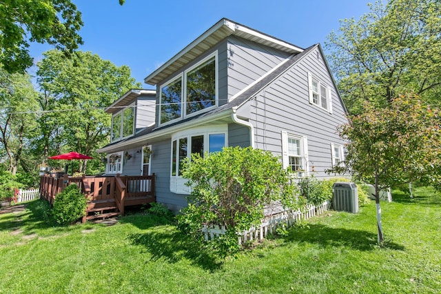 W3527 2nd St, Maiden Rock, WI 54750 - view of property exterior featuring central air condition unit, a deck, and a yard