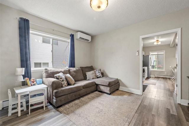 588 Van Buren Ave, Saint Paul, MN 55103 - living room with a wall unit AC, wood finished floors, baseboards, a textured ceiling, and a baseboard radiator