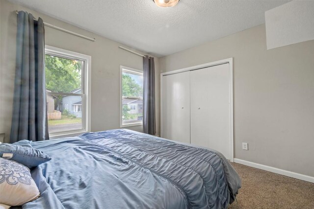 588 Van Buren Ave, Saint Paul, MN 55103 - carpeted bedroom with a textured ceiling, baseboards, and a closet