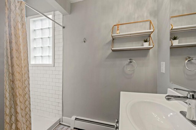 588 Van Buren Ave, Saint Paul, MN 55103 - bathroom with a baseboard radiator, a sink, and a stall shower