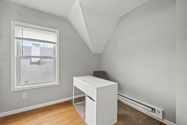 588 Van Buren Ave, Saint Paul, MN 55103 - unfurnished office featuring vaulted ceiling, baseboard heating, baseboards, and light wood-style flooring