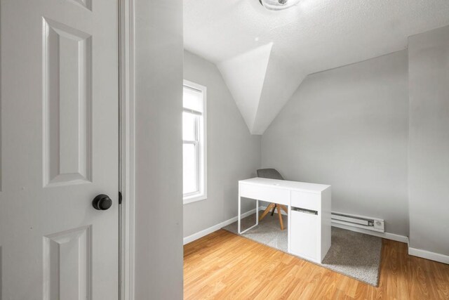 588 Van Buren Ave, Saint Paul, MN 55103 - office space featuring vaulted ceiling, wood finished floors, baseboard heating, a textured ceiling, and baseboards