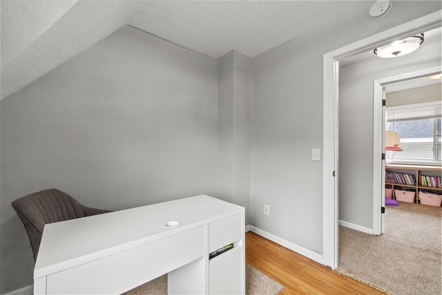 588 Van Buren Ave, Saint Paul, MN 55103 - home office with a textured ceiling, baseboards, vaulted ceiling, and light wood-style floors