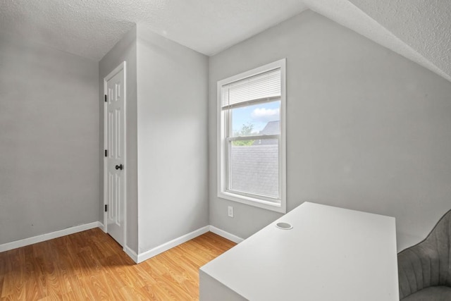 588 Van Buren Ave, Saint Paul, MN 55103 - unfurnished office with light wood-style floors, a textured ceiling, and baseboards