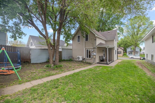 588 Van Buren Ave, Saint Paul, MN 55103 - rear view of property with an outdoor structure, ac unit, a trampoline, and a storage unit