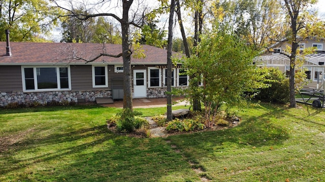 18063 Bernard Trl, Brainerd, MN 56401 - back of property featuring stone siding, a lawn, and a patio area