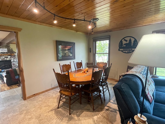 18063 Bernard Trl, Brainerd, MN 56401 - dining area featuring track lighting, ornamental molding, wooden ceiling, baseboards, and light tile patterned floors