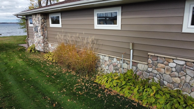 18063 Bernard Trl, Brainerd, MN 56401 - view of side of home with a water view, stone siding, and a yard