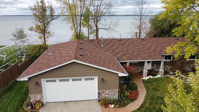 18063 Bernard Trl, Brainerd, MN 56401 - view of front of home with stone siding, roof with shingles, and a water view