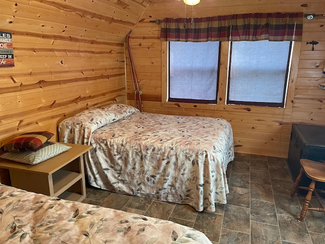 18063 Bernard Trl, Brainerd, MN 56401 - bedroom with wooden walls, lofted ceiling, wooden ceiling, and dark stone finish floors