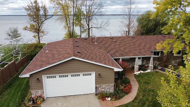 18063 Bernard Trl, Brainerd, MN 56401 - view of front of home featuring stone siding, a water view, and a shingled roof