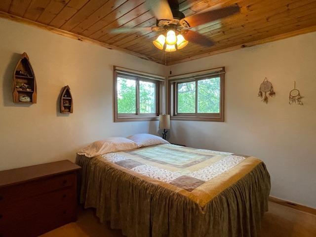 18063 Bernard Trl, Brainerd, MN 56401 - bedroom featuring wood ceiling, a ceiling fan, and carpet floors