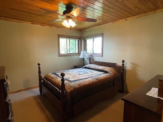 18063 Bernard Trl, Brainerd, MN 56401 - bedroom with wooden ceiling, carpet, and a ceiling fan