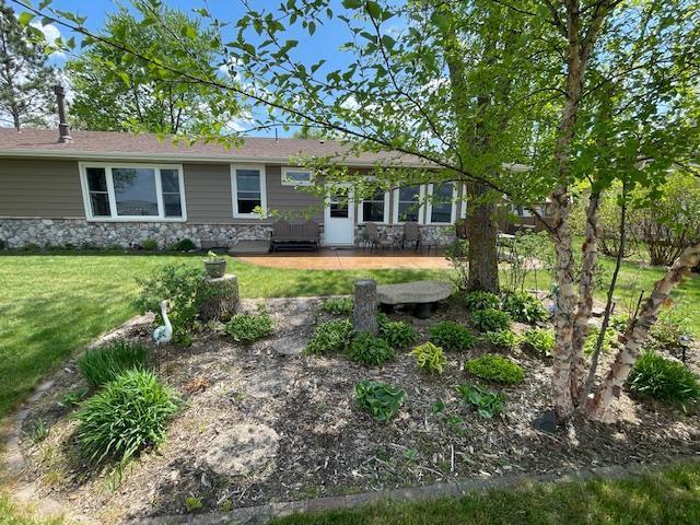 18063 Bernard Trl, Brainerd, MN 56401 - view of front of home with stone siding and a front lawn
