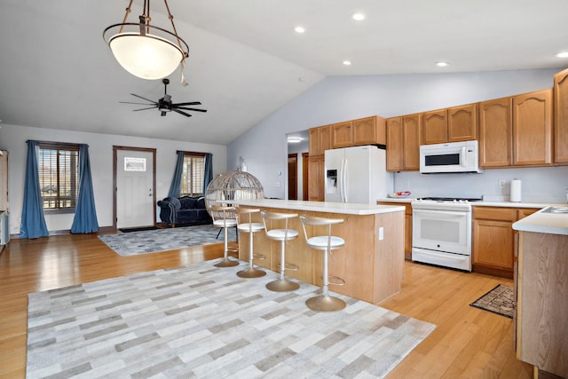 572 172nd St, Pleasant Valley Twp, WI 54015 - kitchen with white appliances, lofted ceiling, open floor plan, light countertops, and light wood finished floors