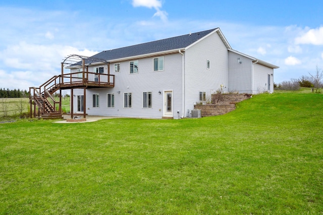 572 172nd St, Pleasant Valley Twp, WI 54015 - back of property featuring stairway, a deck, a lawn, and a patio area