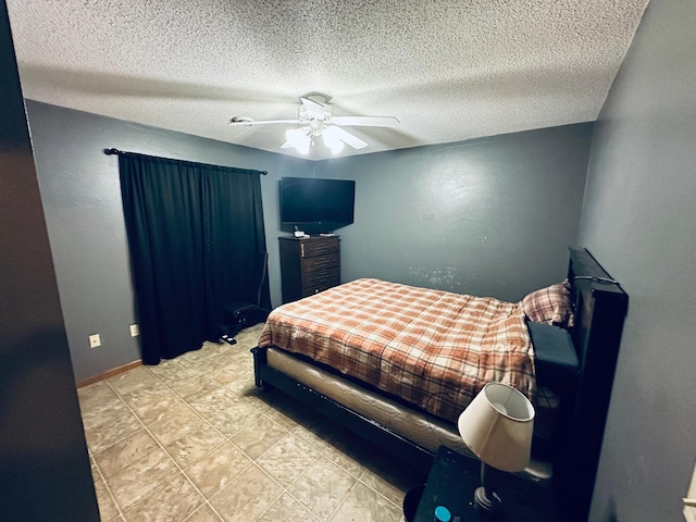 bedroom with baseboards, ceiling fan, and a textured ceiling